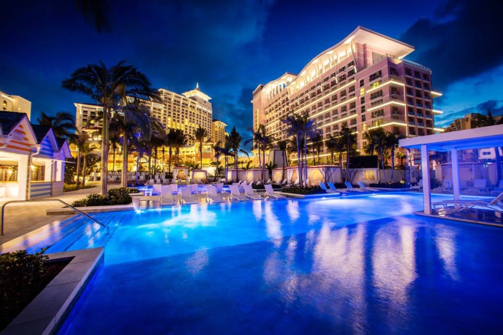 The pool and resort buildings at the Grand Hyatt Baha Mar at night.