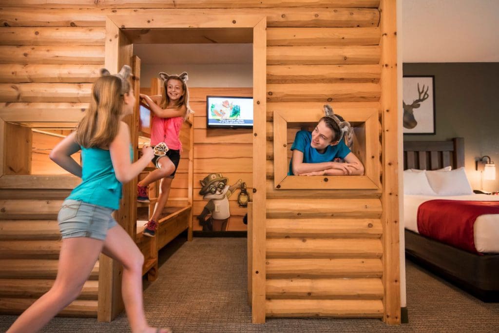 Three kids enjoy their bunk bed room at the Great Wolf Lodge Pocono Mountains, one of the best themed hotels in the United States for families.