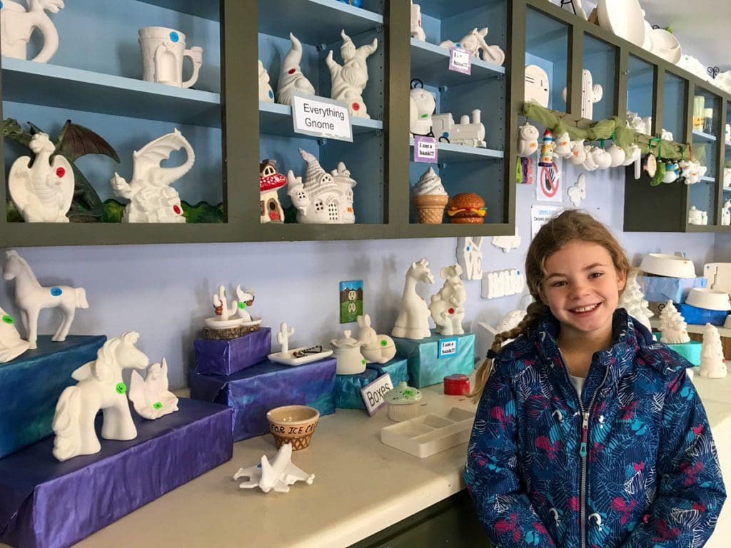 A young girl smiles in the craft room at the YMCA of the Rockies.