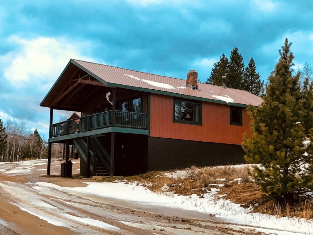 A lodge at YMCA of the Rockies, dusted with snow, one of the best accommodation options at YMCA Snow Mountain Ranch for Families.