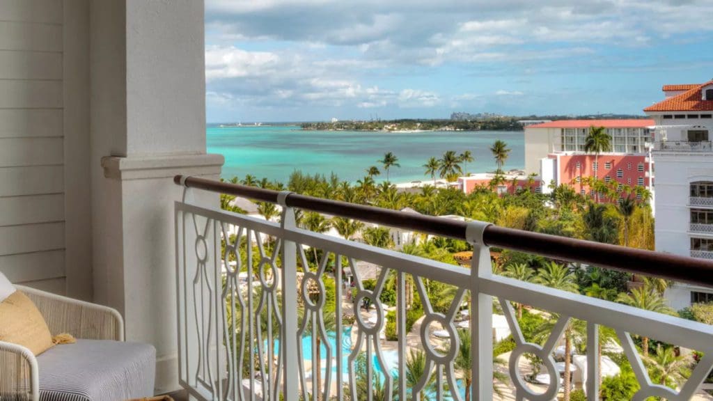 A view from a balcony at the Rosewood Baha Mar, featuring the hotel grounds and an ocean view.