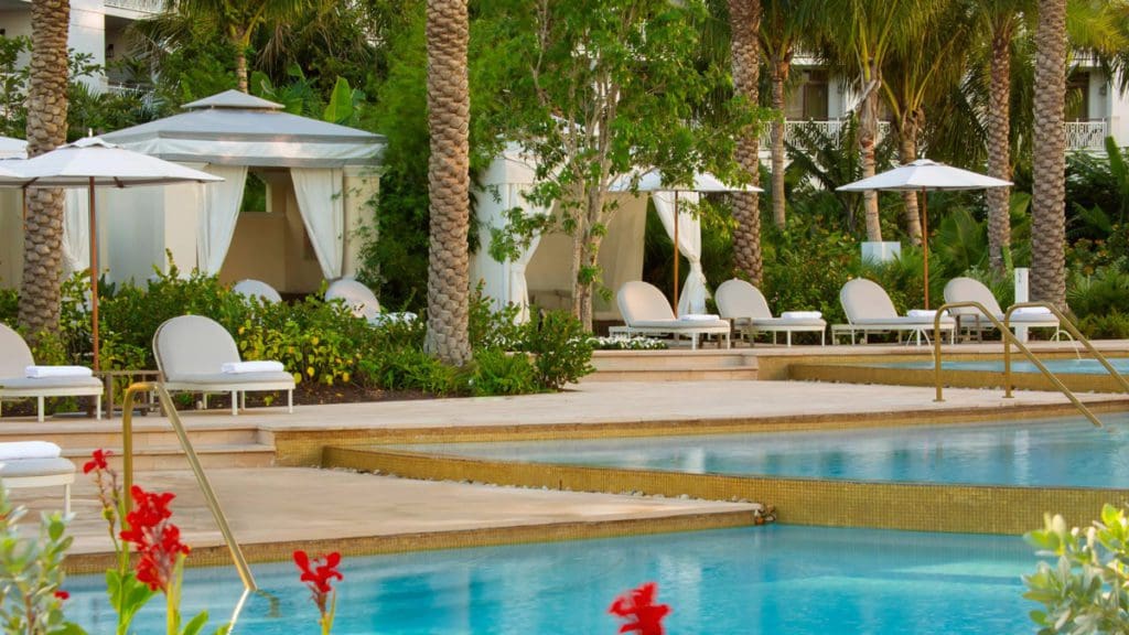 The pool and peaceful cabanas at the Rosewood Baha Mar, awaiting guests for the day, one of the best hotels in the Bahamas for families.