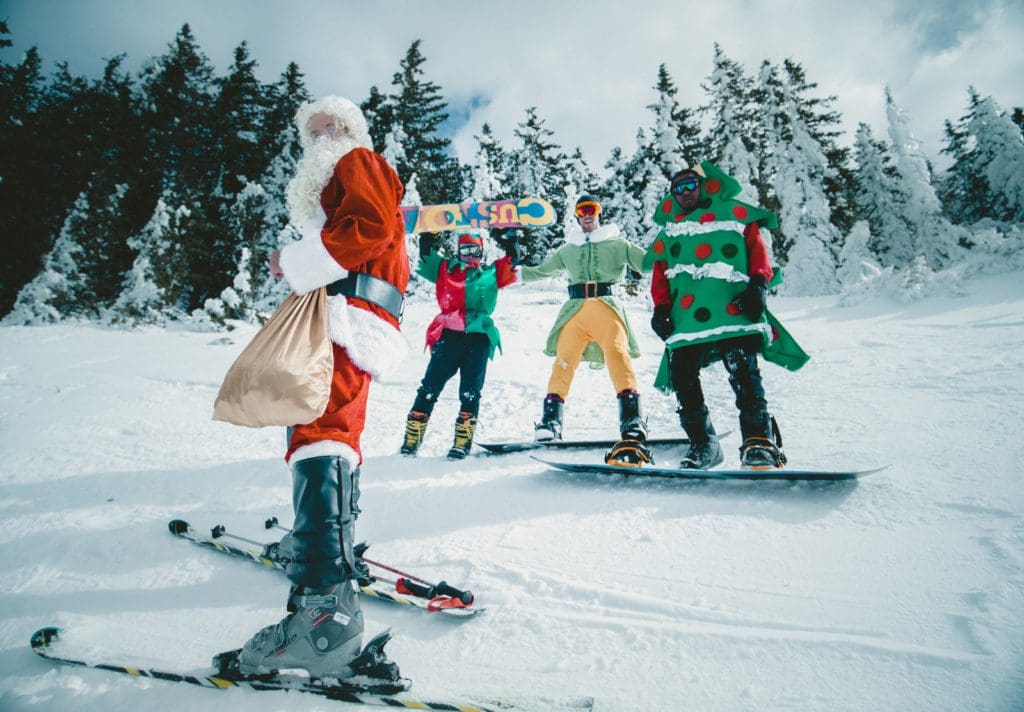 Santa and several elves on skis enjoy a local holiday event near Park City.