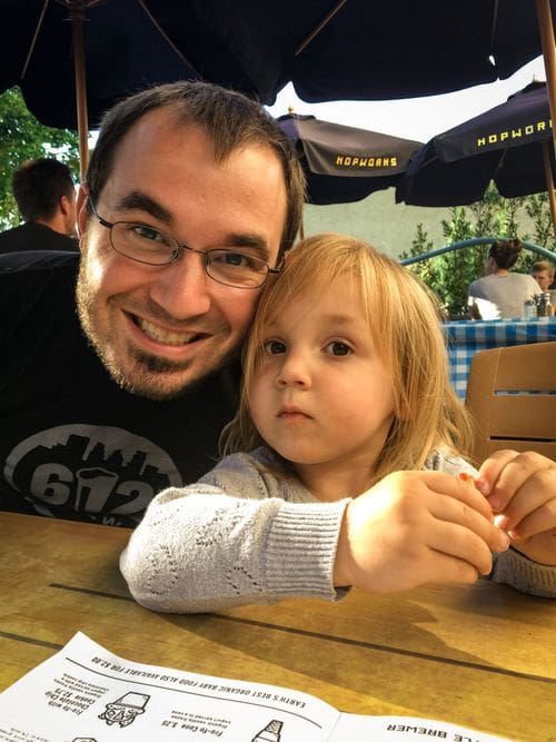 A dad and his young daughter eat at Hopworks Brewery in Portland.