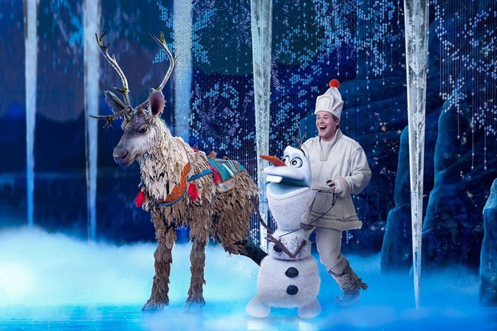 An actor playing Christoph from Disney's Froze acts on stage with Sven and Olaf at the Broadway In Chicago.