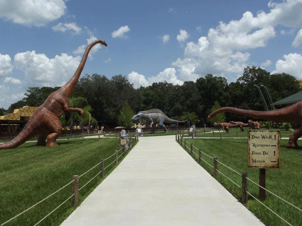 Inside Dinosaur World, one of the best places for a dinosaur-themed vacations in the united states for families, featuring several large dinosaur replicas and wide walking paths.