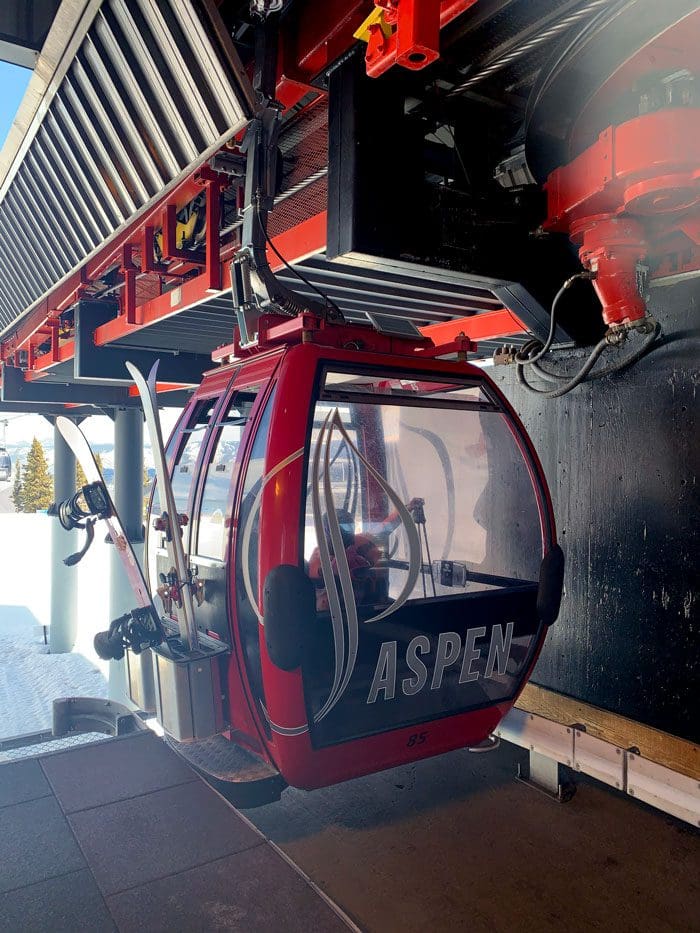 A close up view of one of the red gondolas at Aspen Mountain.