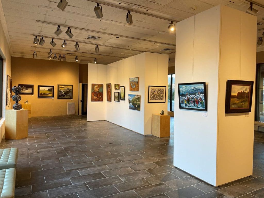 Inside the art gallery of the Lake Placid Center for the Arts, featuring several curated art pieces along the walls.