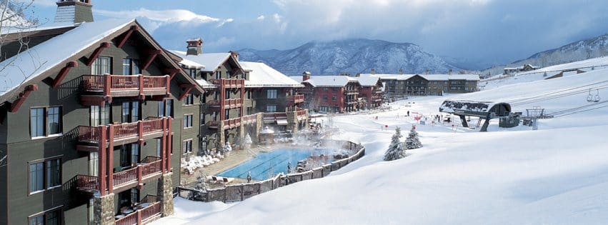 A view of the resort grounds of The Ritz-Carlton Club, Aspen Highlands, covered in snow, one the best places to stay when visiting Aspen with kids during the winter.