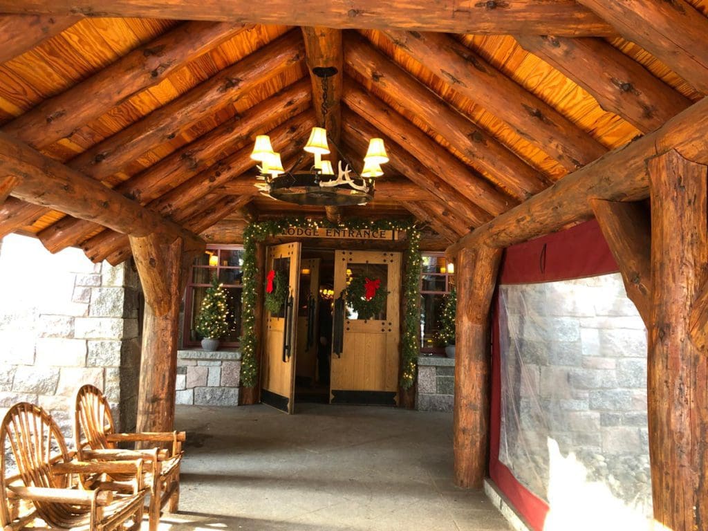 The indoor entrance to the  The Whiteface Lodge, featuring a chandelier and wood ceiling.