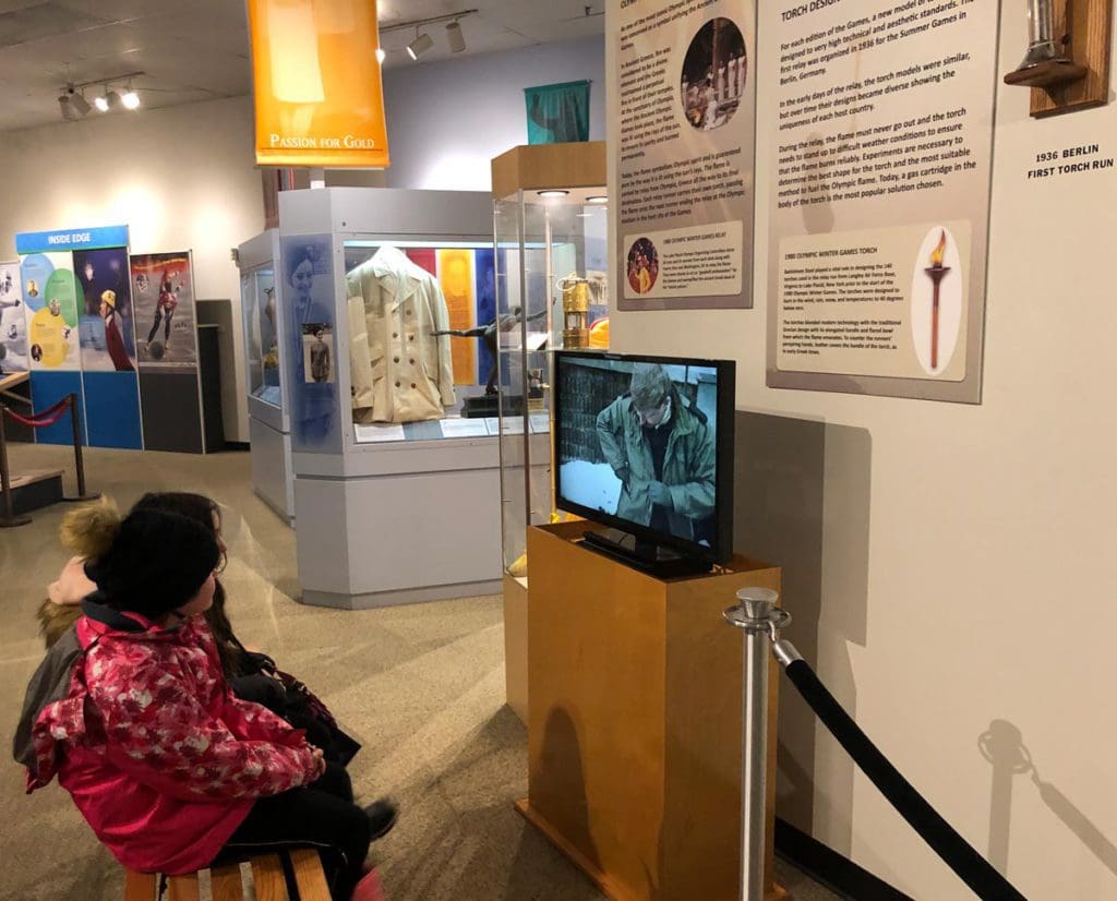 Two kids enjoy an exhibit at the Lake Placid Winter Olympic Museum.