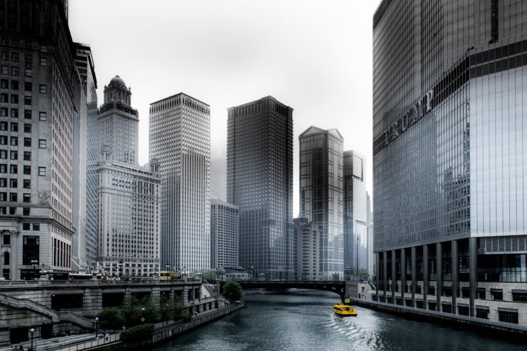 A view of the Chicago skyline, featuring the Chicago River and walkway.