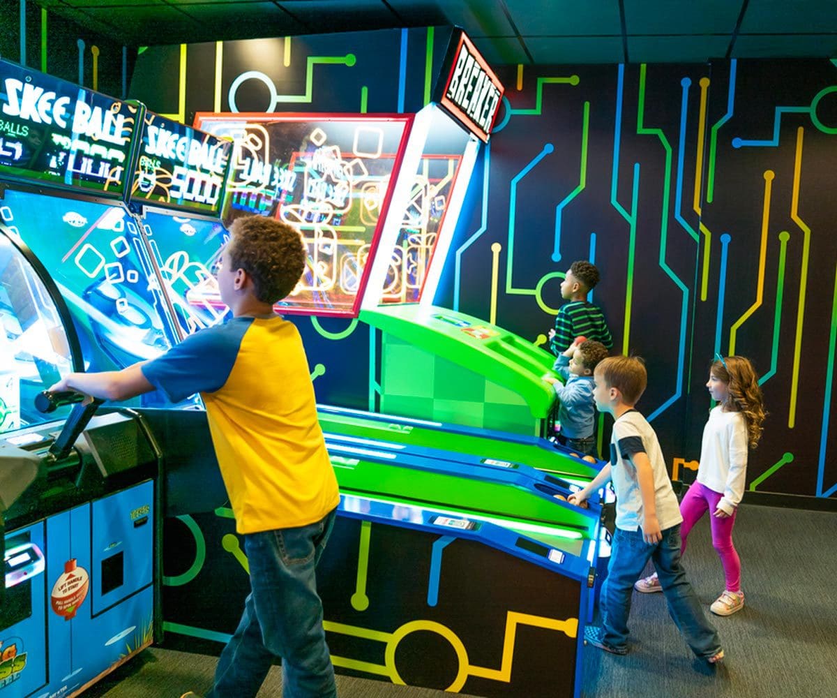 Several kids play games at the arcade on-sight at the Cartoon Network Hotel.
