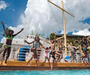 Several kids jump from a play pirate ship at the children's pool at Loews Royal Pacific Resort.