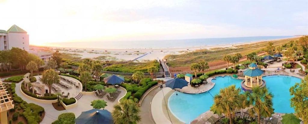 An aerial view of the grounds at Marriott's Barony Beach Club, featuring a pool and beach at one of the Best Marriott Properties in the U.S. for a Family Vacation.