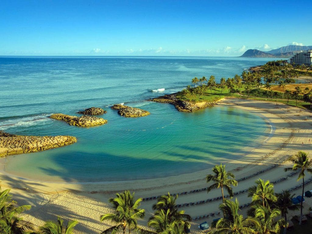 The protected cove near Marriott's Ko Olina Beach Club, featuring calm waters and swaying palm trees.