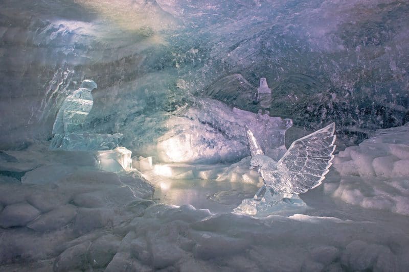 Three predatory birds are carved in ice as part of a display at the Swiss Glacier Cave and Ice Palace.