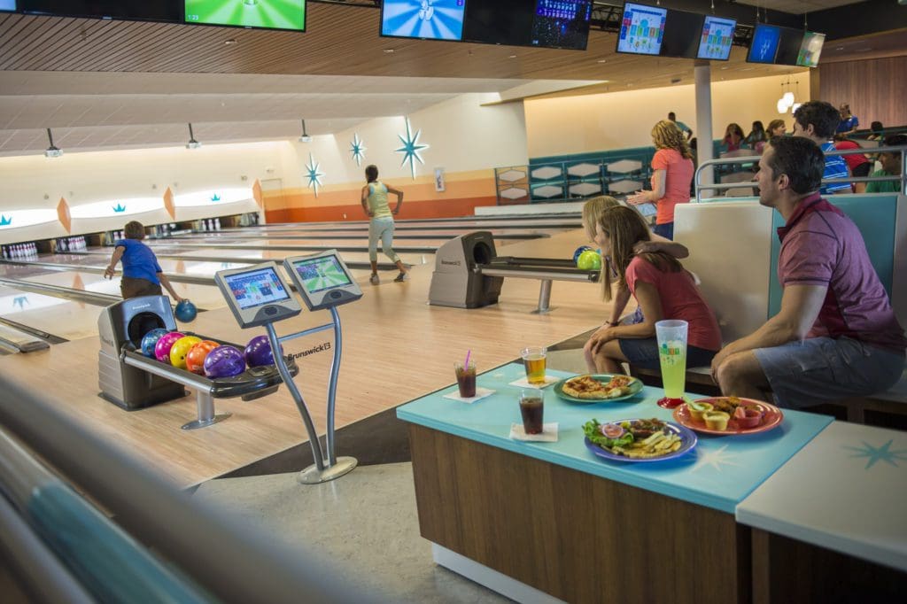 A the bowling alley in the Cabana Bay Beach Resort, with several family members playing the game.