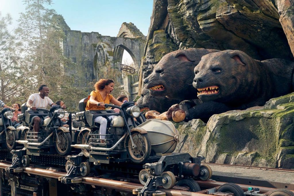A Harry Potter-themed roller coaster races around a track to face a three-headed dog.