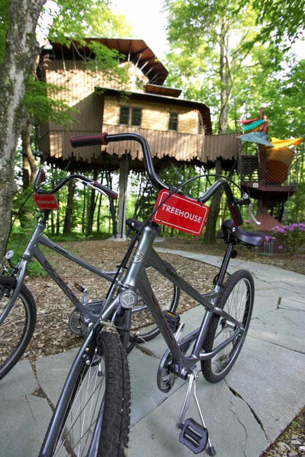 Outside the treehouse accommodation at the Winvian Farm, featuring on-sight bikes outside.
