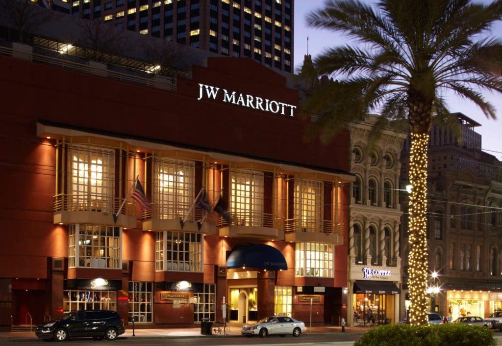 The exterior entrance to JW Marriott New Orleans, well-lit at night, one of the best hotels in New Orleans for families.