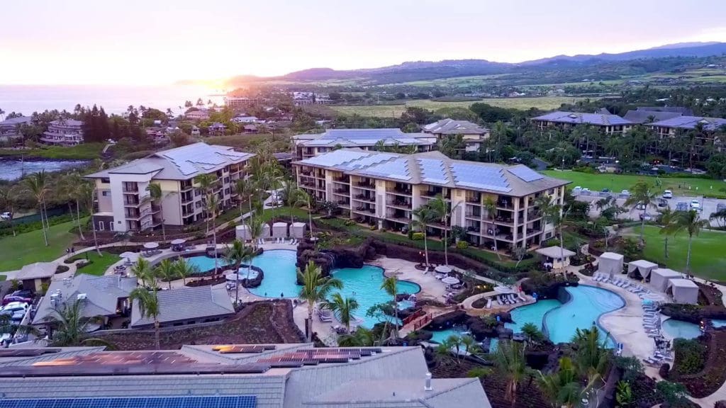 An aerial view of the resort buildings, pools, and lush green spaces at Koloa Landing Resort At Poipu, one of the Best Marriott Properties in the U.S. for a Family Vacation.