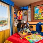 Two kids play together in a LEGO-themed room, while staying at the LEGOLAND California Hotel.