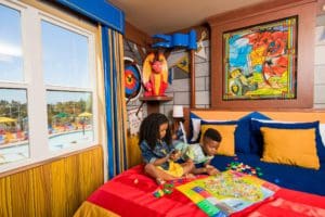 Two kids play together in a LEGO-themed room, while staying at the LEGOLAND California Hotel.