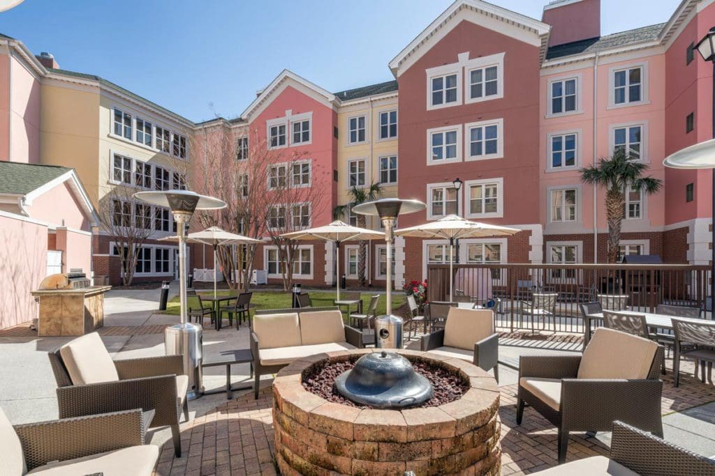 The outdoor patio at Residence Inn by Marriott Charleston Riverview, featuring spacious seating and a large outdoor fire pit and heater.