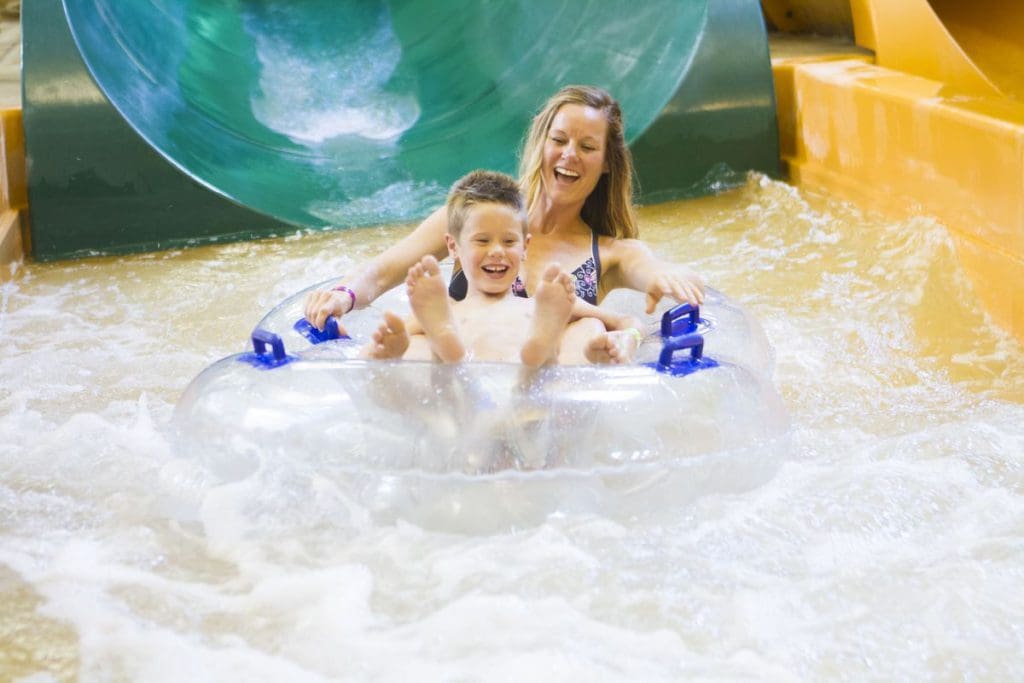 A mom and her young son enjoy a tandem tube water slide ride at Photo Courtesy: Great Wolf Lodge in the Wisconsin Dells.
