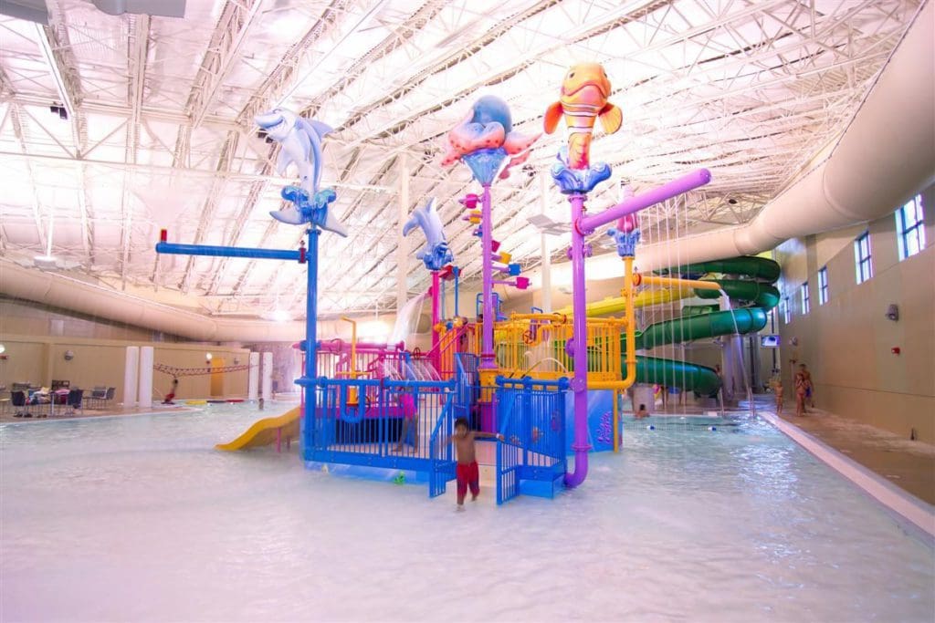 A close up of the large indoor water park play area in a shallow pool at Photo Courtesy: King's Pointe Resort.