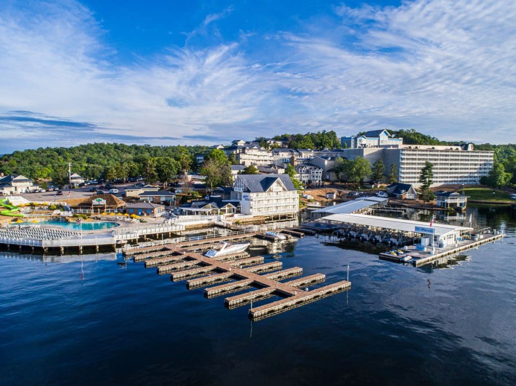 An aerial view of Margaritaville Lake Resort Lake of the Ozarks, featuring its lakeside location, docks, and expansive grounds.