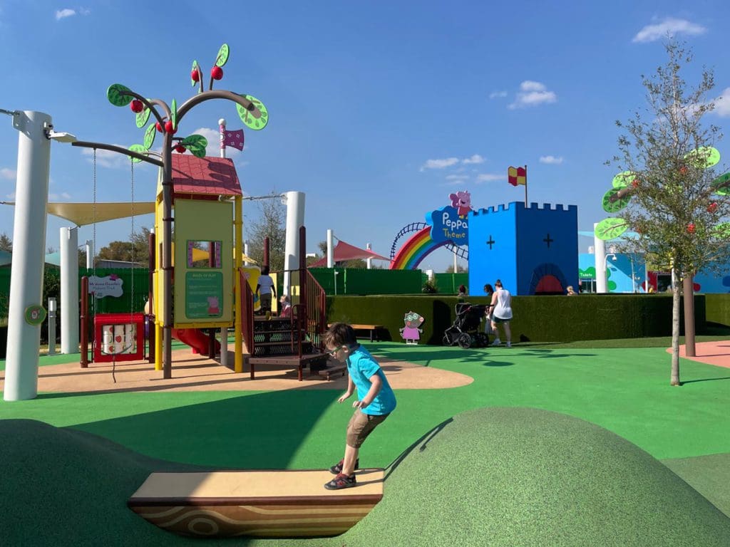 A young boy jumps along a path at the Peppa Pig Theme Park in Florida.