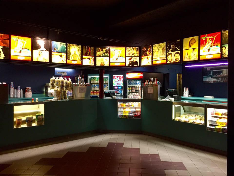 The concessions area at Niantic Cinemas, with loads of popcorn, candy, and soda on the counters.