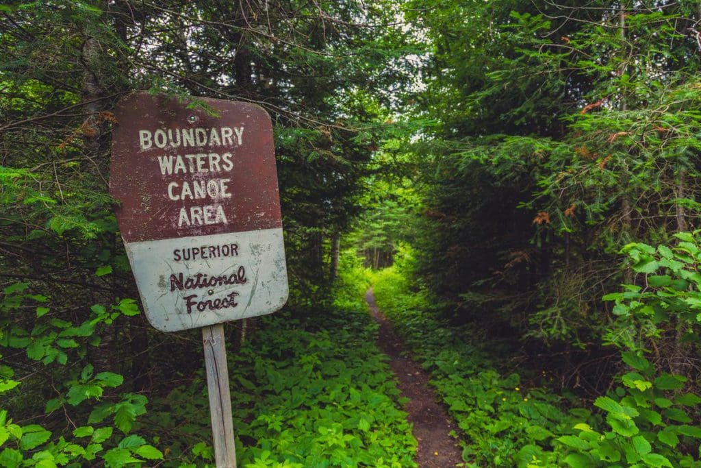A Boundary Waters Canoe Area (BWCA) sign along a portage trail to Bower Trout Lake near Lima Grade on the Gunflint Trail (Superior National Forest) in Northern Minnesota.