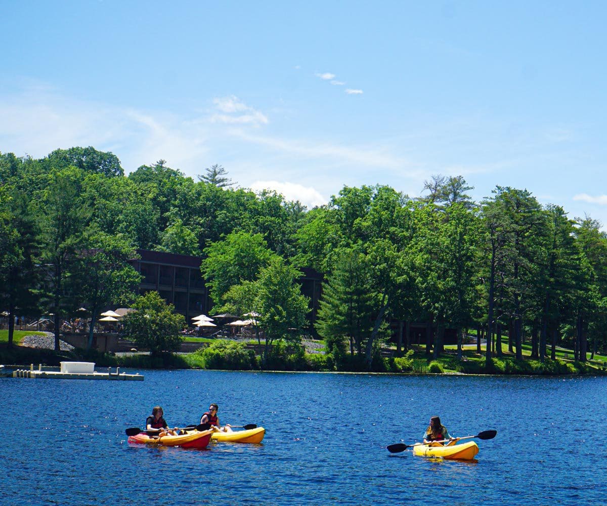 family kayaking in the lake at Woodloch Resort