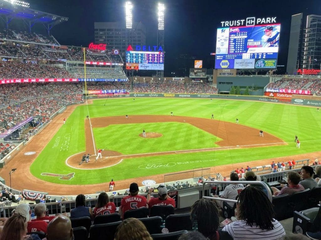 In a packed stadium at Truist Park in Atlanta, onlookers enjoy a baseball game, at one of the best things to do in Atlanta with kids.