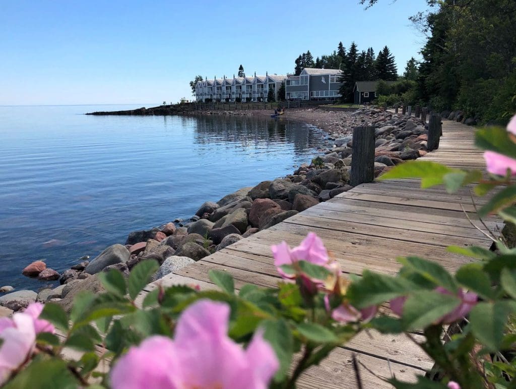 Flowers bloom along a boardwalk leading to Bluefin Bay Family of Resorts, along the shore of Lake Superior.