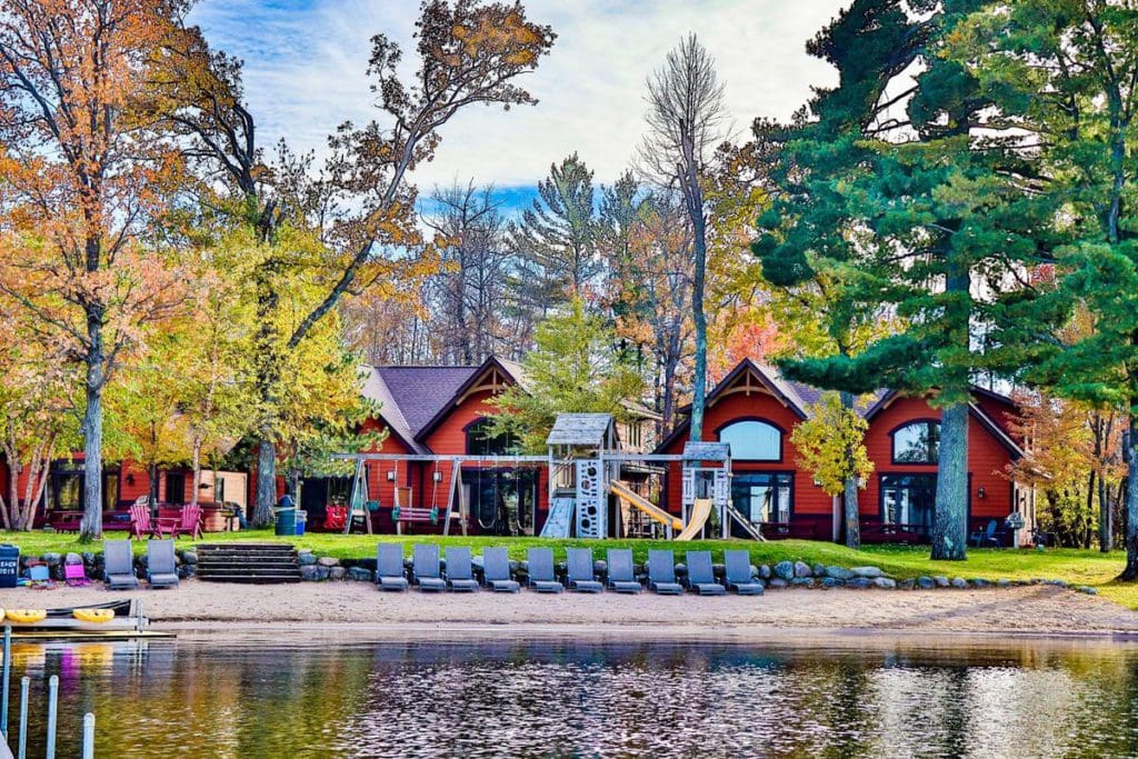 Cozy cabins sit along a lakeshore at Good Ol’ Days Family Resort, one of the best summer resorts in Minnesota for families.