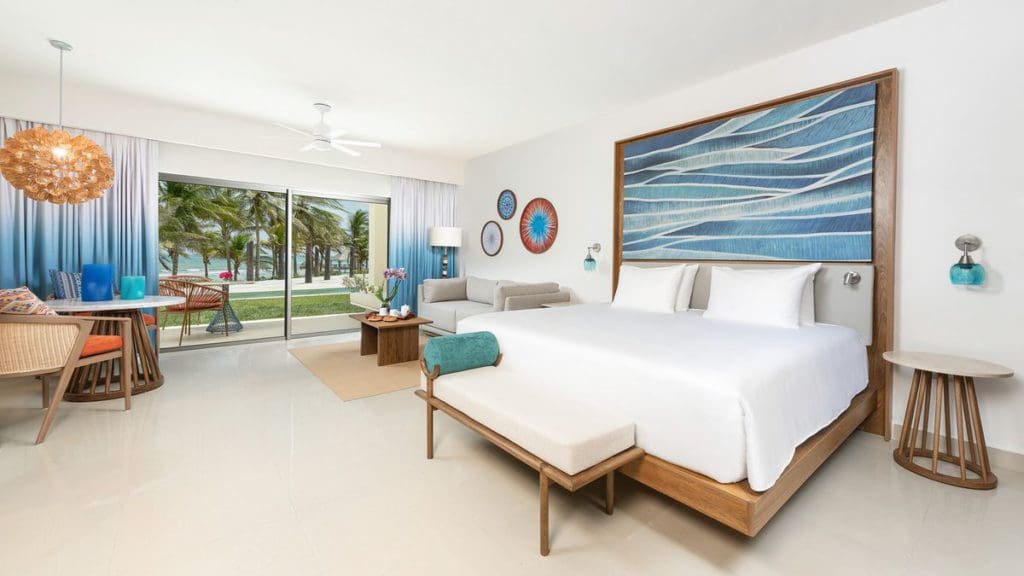 Inside an Oceanfront King Suite at Hyatt Ziva Riviera Cancun, featuring a large bed and airy feel.