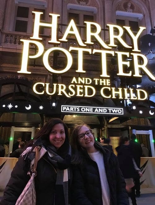 A mom and her daughter stand outside the Broadway Show for Harry Potter and the Cursed Child. 