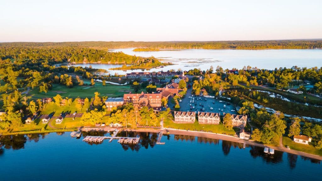 An aerial view of the lakeside Madden’s On Gull Lake, featuring the wooded grounds and long stretch of lakefront.