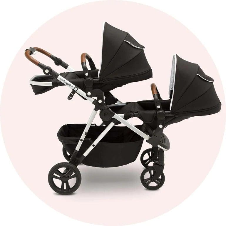 A product shot of the Mockingbird Single-to-Double Stroller in black, fully extended with two seating areas for kids.