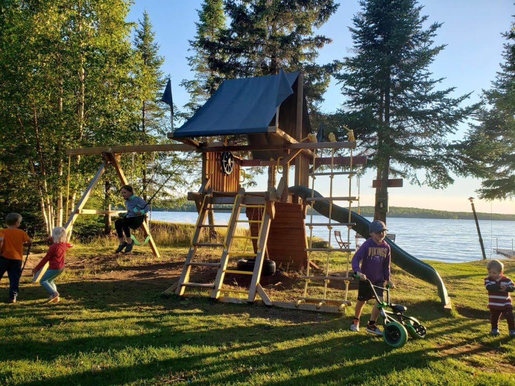 Kids run and play at the lakeside playground at Skyport Lodge & Raven Rock Grill.