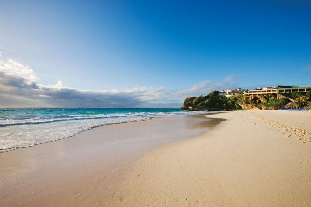 The stunning beach at The Crane Resort, Barbados, with pristine waters and blue skies.