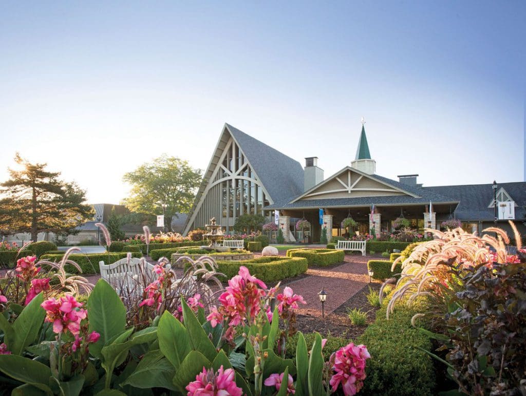 The Abbey Resort on a beautiful sunny day, surrounded by blooming flowers.