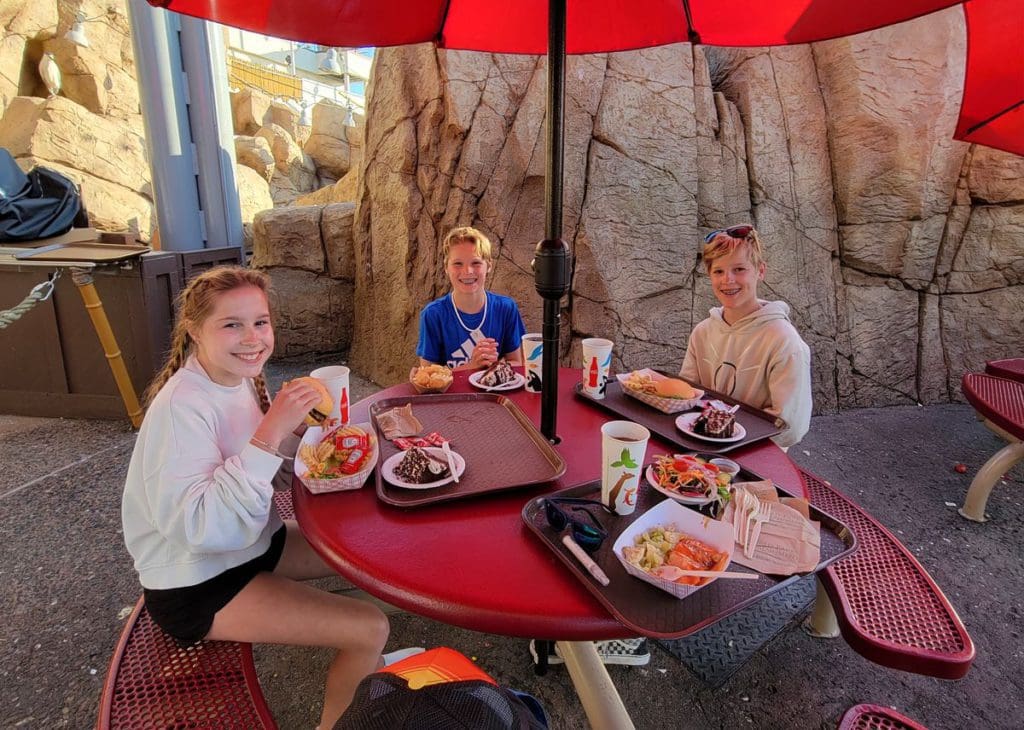 Three teens enjoy a meal at SeaWorld San Diego.