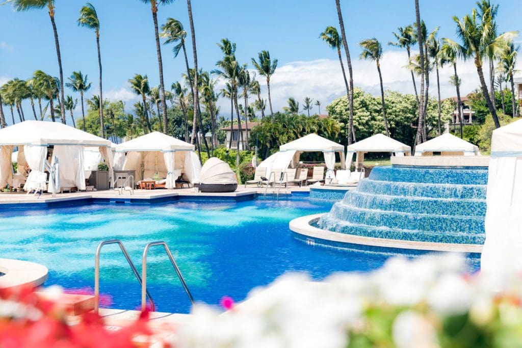 The lovely pool and surrounding pool deck, including luxury cabanas, at Grand Wailea, A Waldorf Astoria Resort.