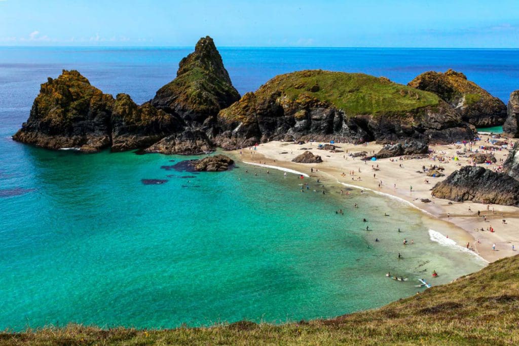 People dot the shore of Kynance Cove, a popular, but secluded beach in Cornwall.