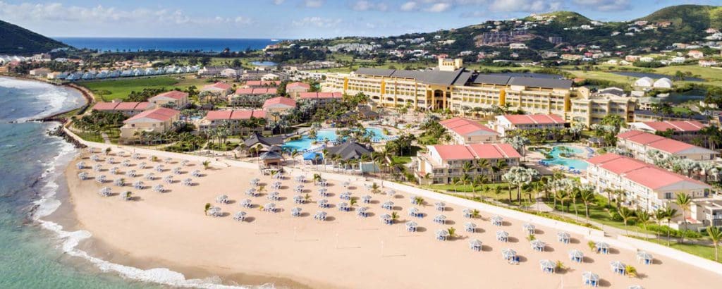 A sweeping view of the grounds at St Kitts Marriott & The Royal Beach Casino, including a large beach and lovely resort buildings at one of the best Marriott Resorts in the Caribbean for families.
